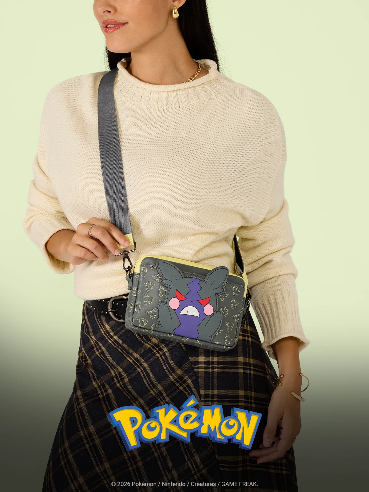 Yellow background with model wearing Loungefly Pokemon Crossbody Bag
